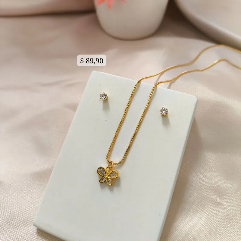 CONJUNTO INFANTIL COM PINGENTE DE LAÇO CRAVEJADO EM MICRO ZIRCONIA E BRINCO PONTO DE LUZ