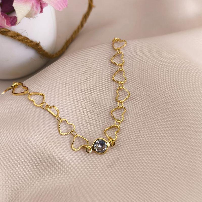 PULSEIRA COM CORAÇÕES CRAQUELADOS E PEDRA DE ZIRCONIA NO MEIO